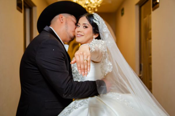 Mexican bride and groom embracing