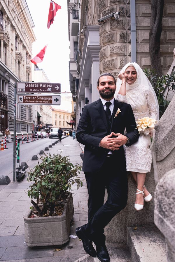 Bride and groom smiling on a city street